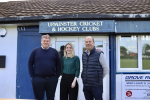 Julia Lopez MP with two people from Upminster Cricket Club outside the pavilion.